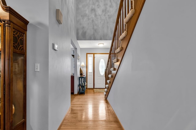 entrance foyer featuring light wood-style floors and stairway