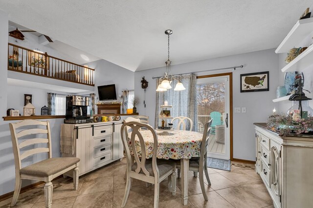 dining area featuring baseboards, lofted ceiling, a textured ceiling, and light tile patterned floors