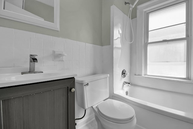 bathroom with  shower combination, tile walls, vanity, and toilet