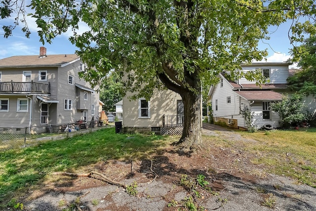 back of property with fence and a lawn