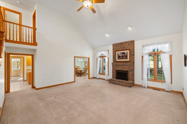 unfurnished living room featuring a fireplace, carpet floors, ceiling fan, and high vaulted ceiling