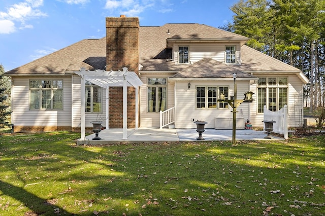 rear view of property with a lawn, a chimney, a pergola, and a patio area