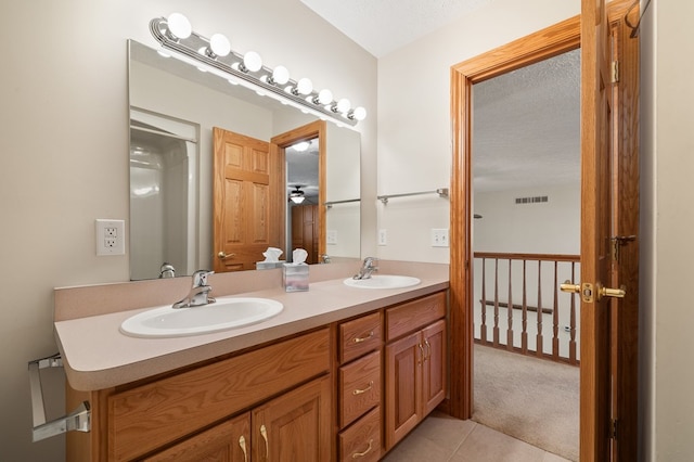 full bath with double vanity, visible vents, tile patterned flooring, and a sink