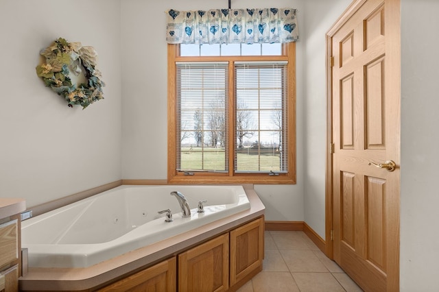 full bath featuring a jetted tub, baseboards, and tile patterned floors
