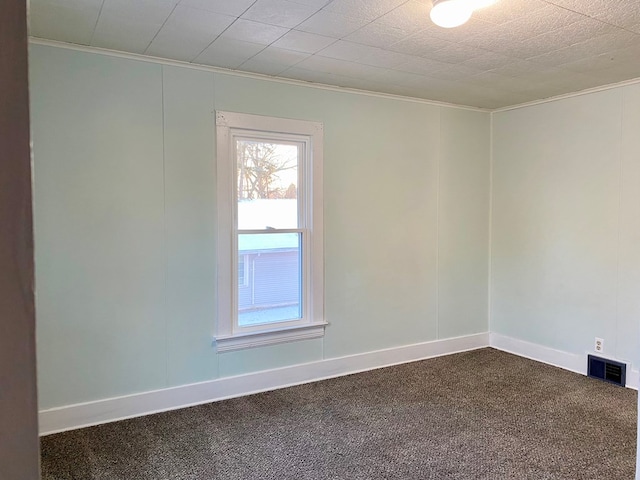 carpeted empty room featuring crown molding