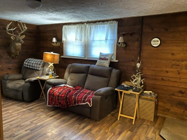 living room with dark hardwood / wood-style floors and wood walls