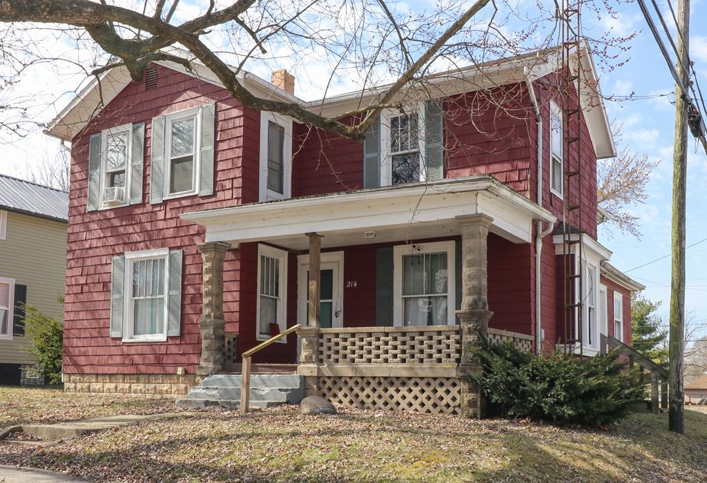 214 Park St, Willard, OH 44890 - view of front facade with covered porch and a chimney