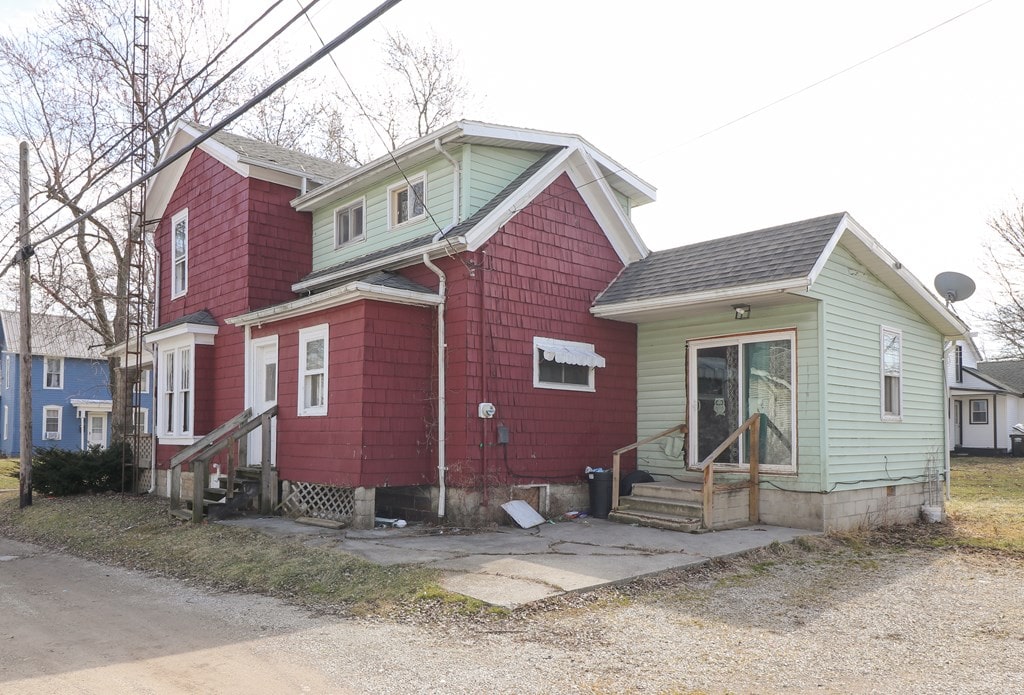 214 Park St, Willard, OH 44890 - view of front of home featuring a shingled roof and entry steps