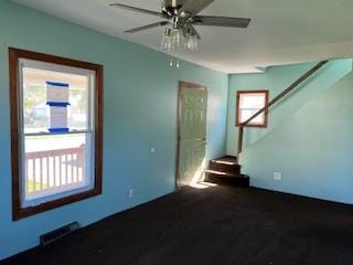 spare room featuring ceiling fan and a healthy amount of sunlight