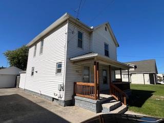 back of property with covered porch