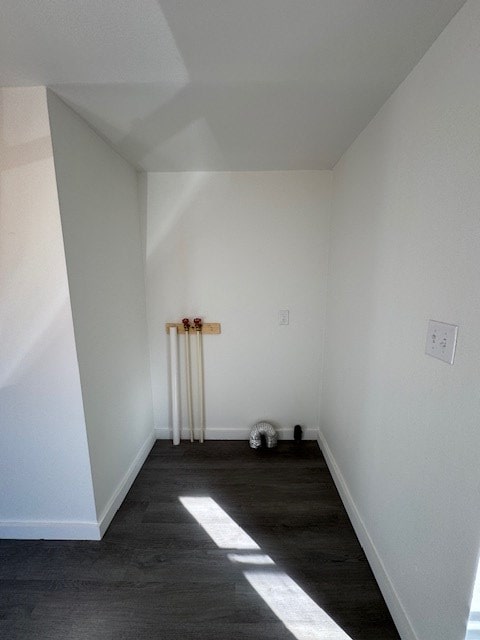 empty room featuring wood finished floors and baseboards