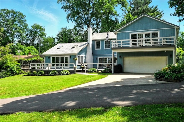 415 Lakeshore Rd, Ashland, OH 44805 - view of front facade with a garage, driveway, a chimney, a front yard, and a metal roof