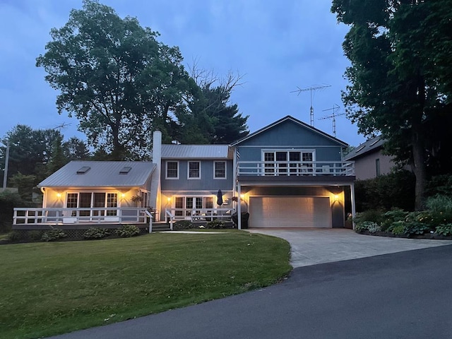 415 Lakeshore Rd, Ashland, OH 44805 - view of front of home with concrete driveway, an attached garage, a front yard, a metal roof, and a chimney