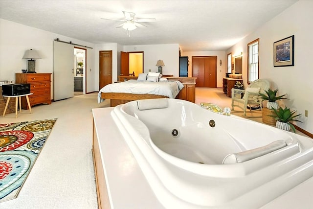 415 Lakeshore Rd, Ashland, OH 44805 - bedroom featuring light colored carpet, a barn door, and ceiling fan