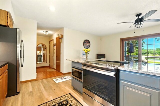 415 Lakeshore Rd, Ashland, OH 44805 - kitchen with appliances with stainless steel finishes, light wood-type flooring, a ceiling fan, light stone counters, and recessed lighting