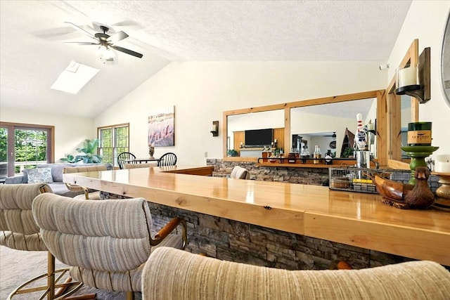 415 Lakeshore Rd, Ashland, OH 44805 - living room featuring a skylight, ceiling fan, high vaulted ceiling, and a textured ceiling