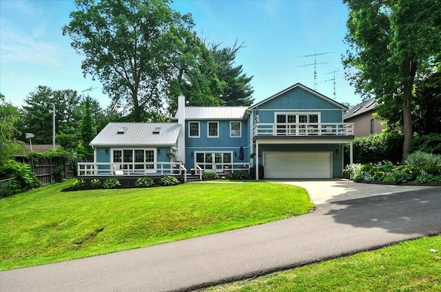 415 Lakeshore Rd, Ashland, OH 44805 - view of front of home with an attached garage, driveway, a chimney, a metal roof, and a deck
