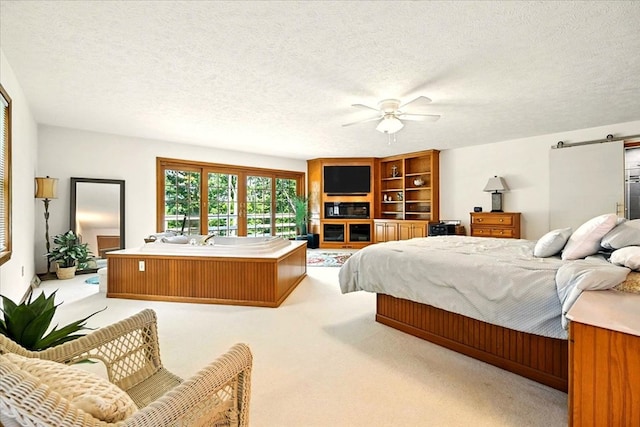 415 Lakeshore Rd, Ashland, OH 44805 - bedroom featuring a barn door, light colored carpet, a textured ceiling, and ceiling fan