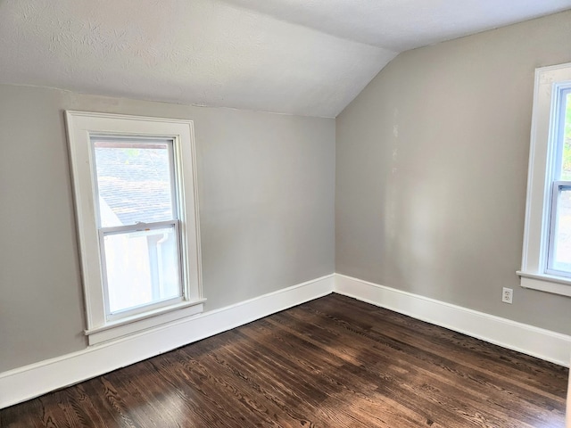 bonus room featuring hardwood / wood-style floors, a textured ceiling, and vaulted ceiling