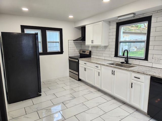 kitchen with decorative backsplash, wall chimney range hood, sink, black appliances, and white cabinets