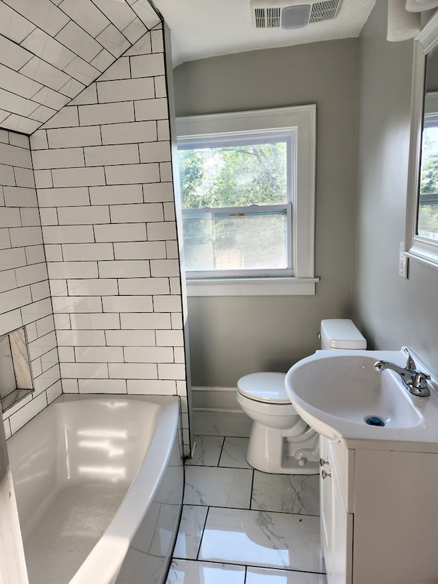 bathroom featuring vanity, toilet, and vaulted ceiling