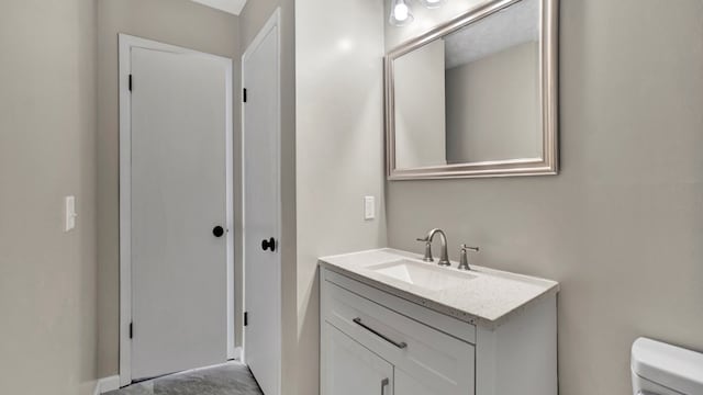 bathroom featuring vanity and toilet