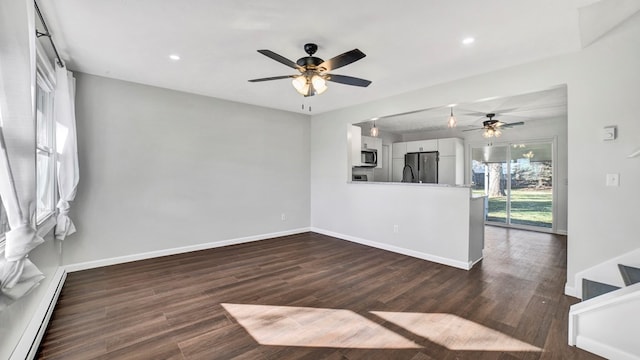 interior space with dark hardwood / wood-style floors, ceiling fan, and a baseboard radiator