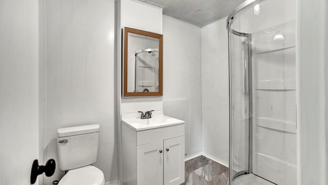 bathroom with vanity, toilet, an enclosed shower, and a textured ceiling