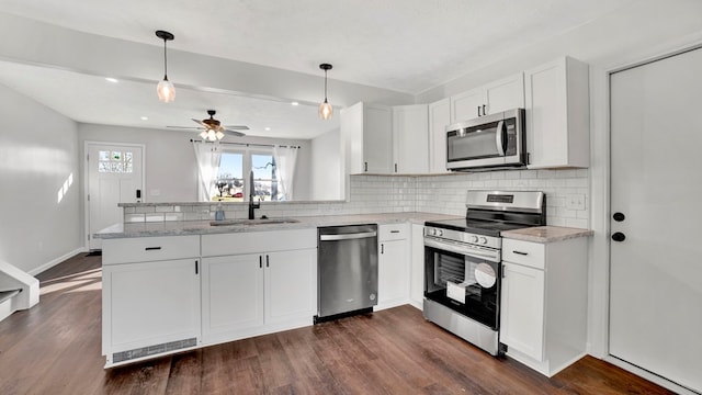 kitchen featuring white cabinets, ceiling fan, decorative light fixtures, kitchen peninsula, and stainless steel appliances