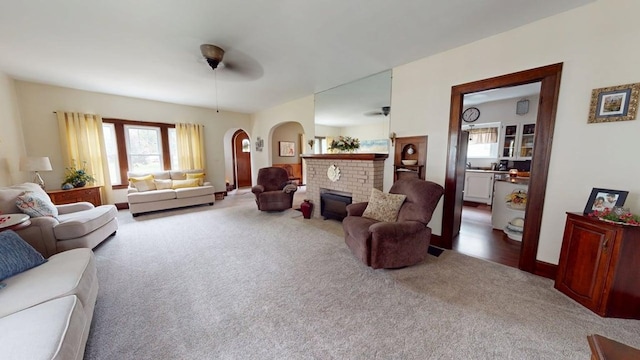 528 Maplewood St, Willard, OH 44890 - living room featuring carpet, arched walkways, plenty of natural light, and a fireplace