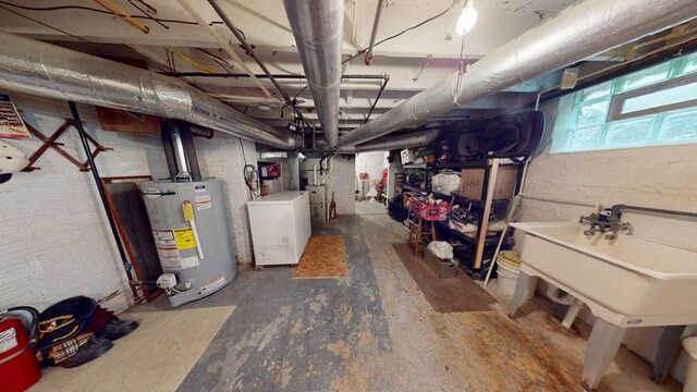 528 Maplewood St, Willard, OH 44890 - basement featuring water heater and washer / dryer