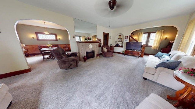 528 Maplewood St, Willard, OH 44890 - living area with arched walkways, a ceiling fan, carpet flooring, and a brick fireplace