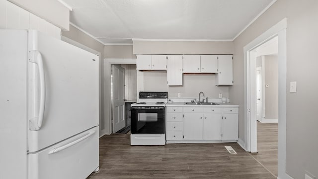 kitchen featuring white appliances, crown molding, dark wood-type flooring, sink, and white cabinetry