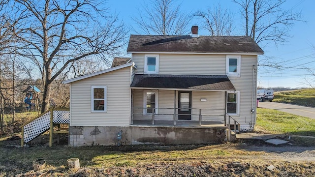 rear view of property with covered porch