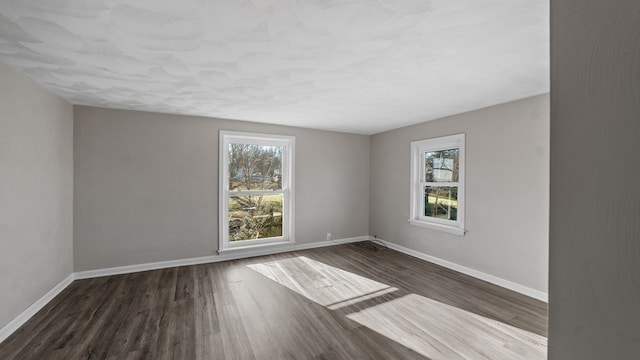 spare room featuring dark hardwood / wood-style floors