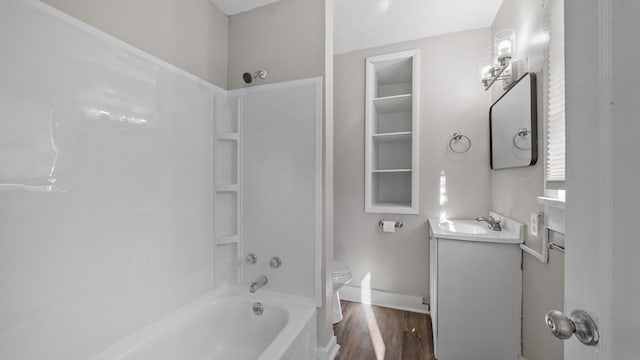 full bathroom featuring washtub / shower combination, wood-type flooring, vanity, and toilet