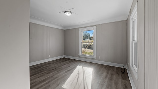 unfurnished room featuring crown molding and dark hardwood / wood-style floors