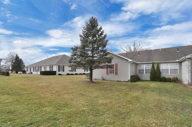 view of front of house with a front lawn and roof with shingles