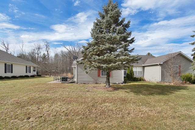 view of front of house with a patio and a front yard