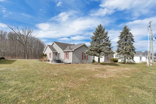 view of front of house featuring a front lawn and a patio area