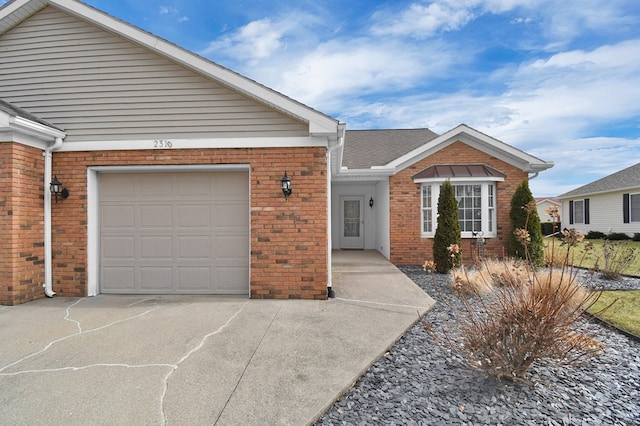 ranch-style home with driveway, brick siding, roof with shingles, and an attached garage