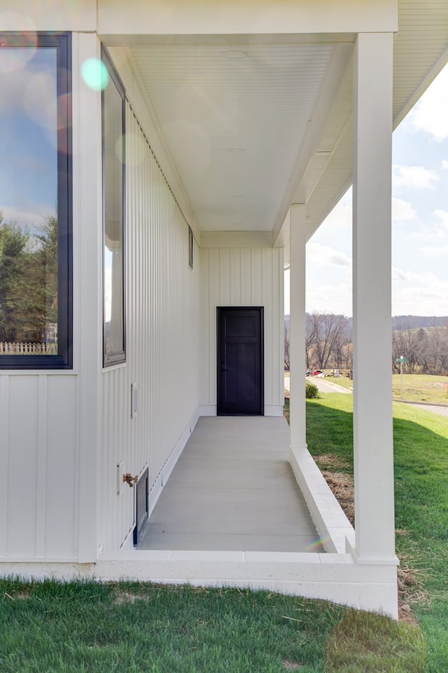 view of exterior entry with a lawn