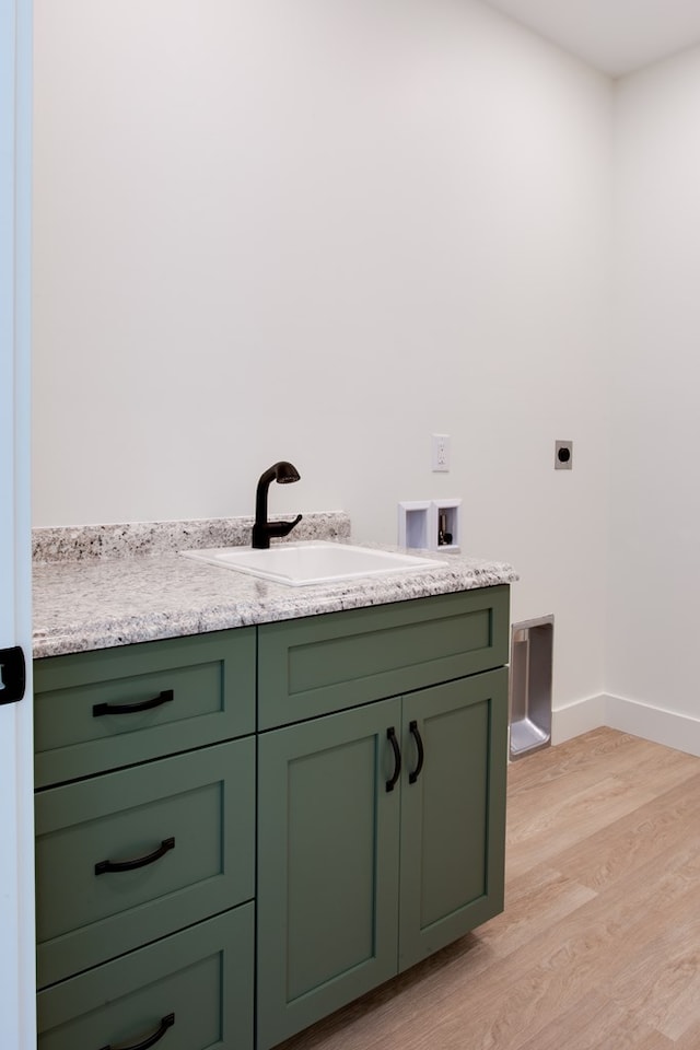 bathroom featuring wood-type flooring and sink