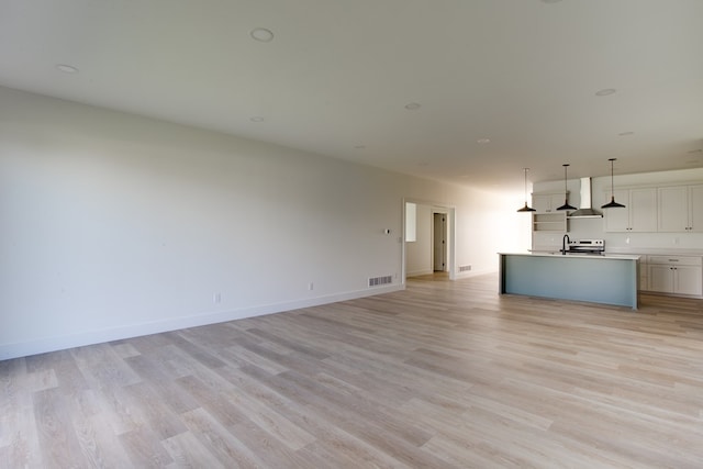 unfurnished living room with light hardwood / wood-style floors