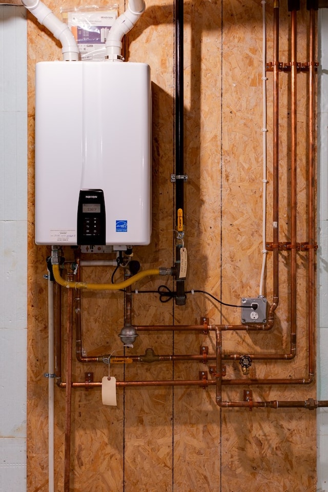 utility room with tankless water heater