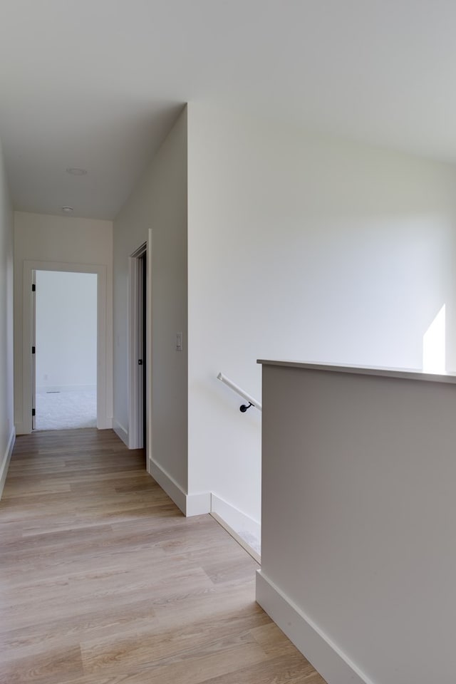 hall with light hardwood / wood-style flooring