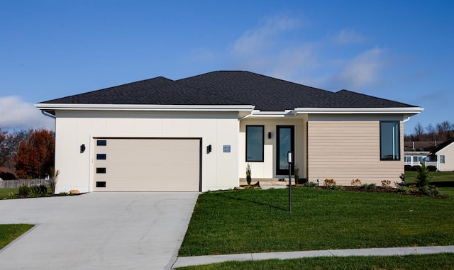 view of front of house featuring a front yard and a garage