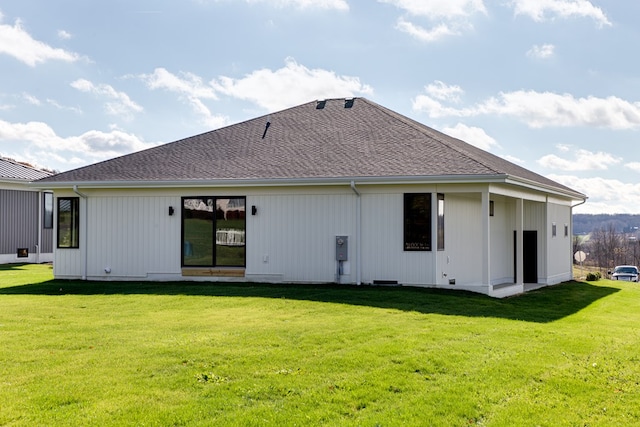 rear view of house featuring a yard