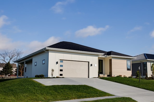 view of front of home featuring a garage and a front lawn