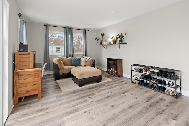 sitting room featuring baseboards and wood finished floors